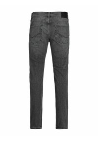 Vaqueros de mezclilla gris con un corte slim, que presentan bolsillos traseros en un diseño clásico y una textura sutil. Terminado con una etiqueta en la cintura de color negro.