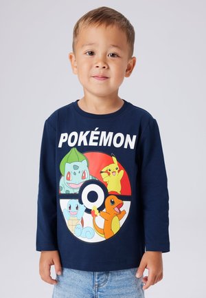 Navy long-sleeve shirt featuring colorful Pokémon characters in a circular design; bold "POKÉMON" text above the graphic.