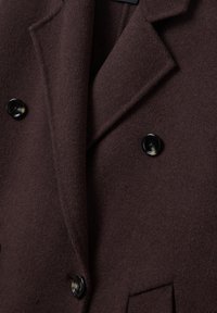 Dark brown wool coat with wide lapels, three black marbled buttons, and a front pocket visible near the bottom edge.