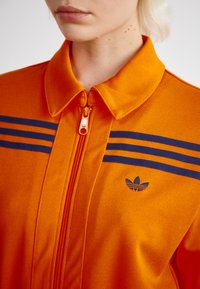 adidas Originals JUMPSUIT - Kombinezon - unity orange