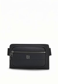 Black textured leather waist bag with front zip pocket and silver metal "HUGO" logo on plain background.