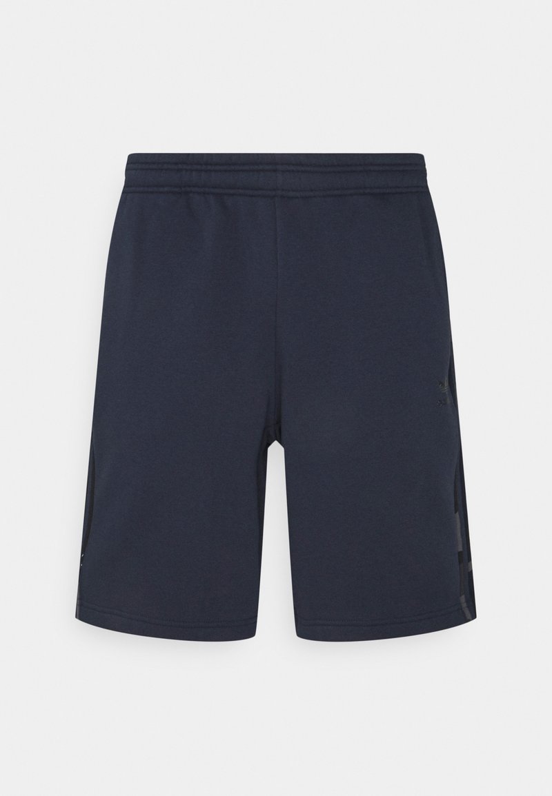 Tamsiai mėlynos sportinės šortai, pagaminti iš minkštos medžiagos, su elastinga juostele juosmenyje ir šoninėmis medžiaginėmis dalimis, kurios užtikrina oro pralaidumą. Paprastas dizainas, be raštų.