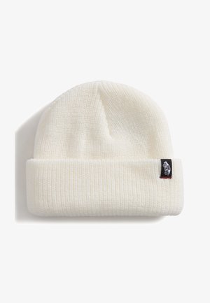 Cream-colored beanie made of ribbed knit fabric. Cuffed design with a black label featuring white text and a red accent. Soft texture.