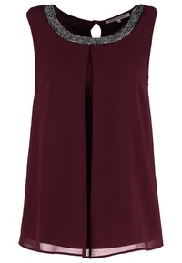 Burgundy ärmlös topp med nyckelhål bak och en dekorativ pärlhalsringning. Tillverkad av ett lätt tyg har den en flödande design.