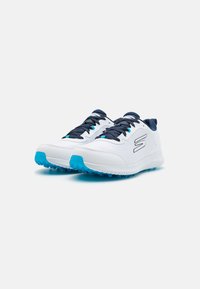 White athletic shoes with a textured upper, navy laces, light blue accents, and a durable rubber sole featuring small traction studs.