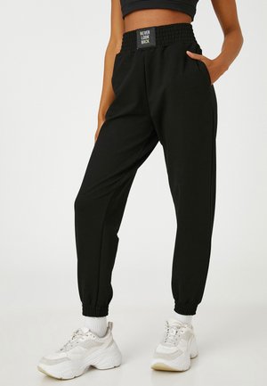 JOGGER DETAIL ELASTIC WAIST. - Pantalones deportivos - black