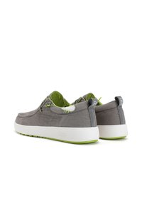 Gray canvas shoes with green accents, a white rubber sole, lace-up design, and pull tabs at the back. Smooth texture and casual style.