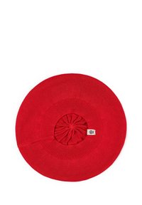 Red knitted hat with a wide brim and textured center, featuring a gathered design. Tag visible at the base of the crown. Smooth texture.