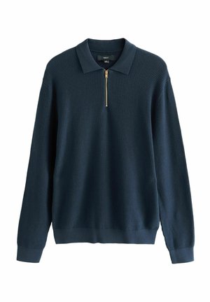 Granatowy sweter z fakturowanym wzorem w wafle, z długimi rękawami i kołnierzem na pół zamek z złotym zamkiem.