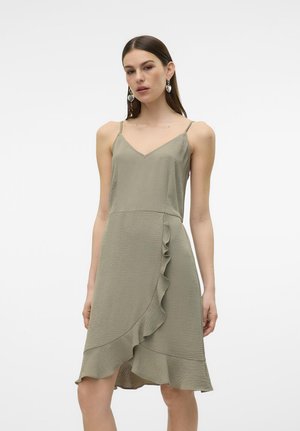 Satin olive green dress with thin adjustable straps, V-neck, and asymmetrical ruffled hem detail. Textured fabric and flowing fit.