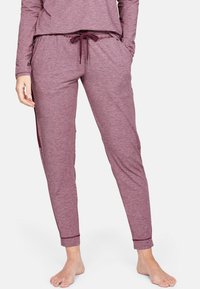 Bordové tepláky vyrobené z měkké, texturované látky. Mají elastický pas se šňůrkou, boční kapsy a zúžené manžety na kotnících.