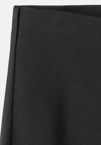 Tela negra con una textura suave y un ligero brillo, con bordes limpios y cosidos. El material parece ligero y elástico.