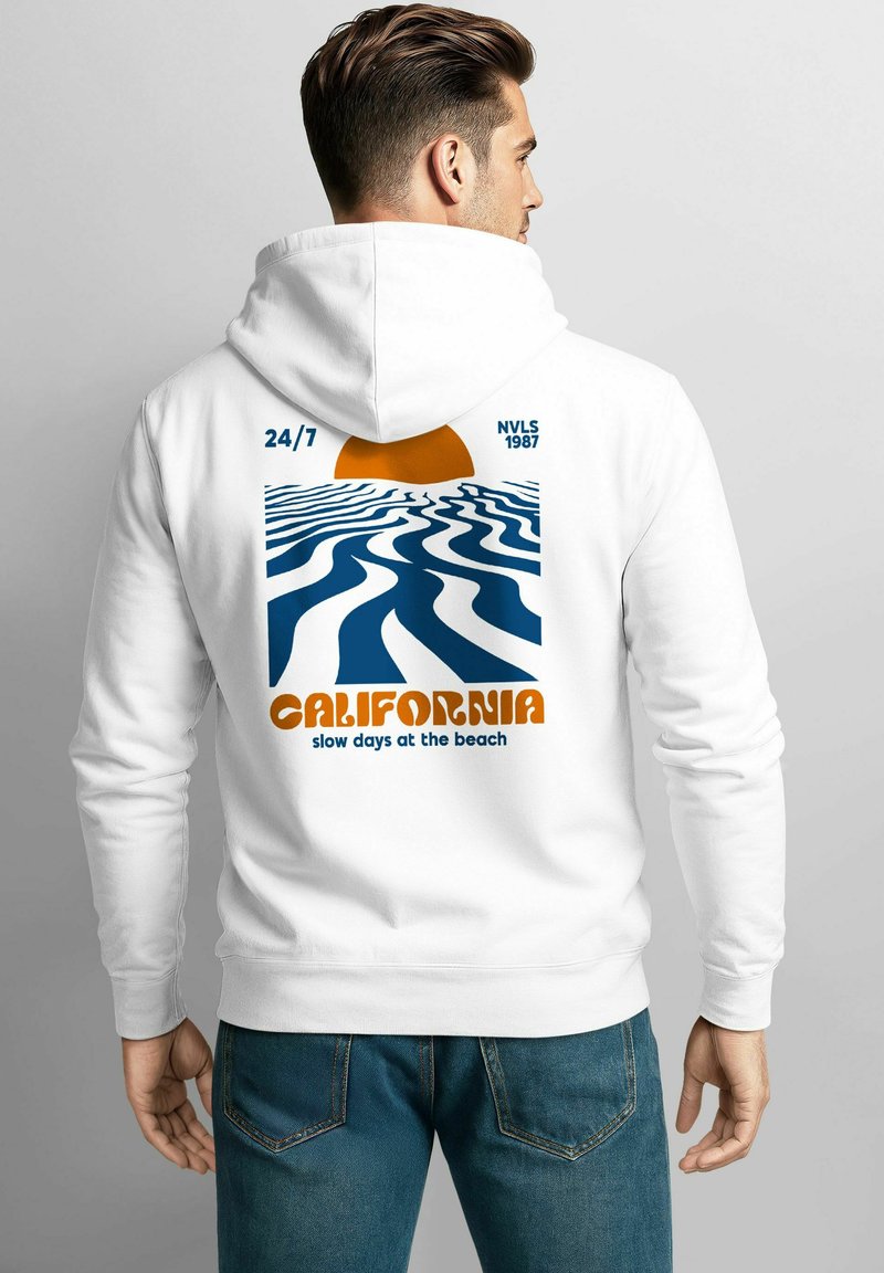 White hoodie featuring a graphic on the back with wavy blue lines, an orange sun, and the text "CALIFORNIA slow days at the beach."