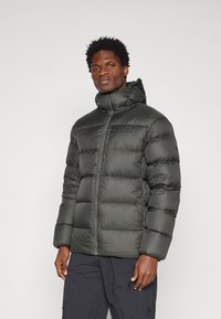 Casaco acolchoado verde escuro com capuz, fecho de correr e punhos elásticos. Apresenta uma textura suave e brilhante, com um design ajustado.