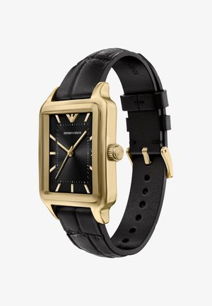 Rechteckige Uhr in Goldton mit schwarzem strukturiertem Zifferblatt, goldenen Stundenmarkierungen und schwarzem Lederarmband mit Steppnähten und Metallschließe.