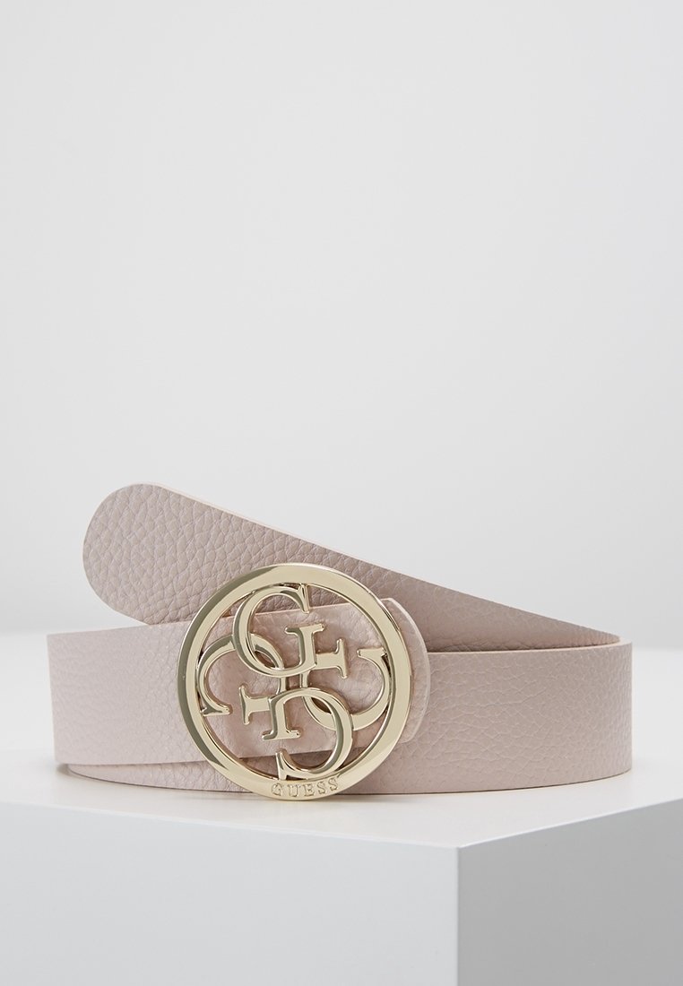 Ceinture en cuir rose clair texturé avec une boucle ronde dorée comportant les lettres entrelacées G et S et le logo Guess.