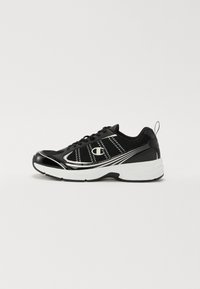 Black athletic shoe with mesh panels, shiny black accents, silver detailing, and a cushioned white midsole. Features laces and a pull tab.