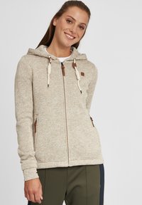 Light beige hooded sweatshirt made of textured fabric, featuring brown accents, a front zipper, and adjustable drawstrings on the hood.
