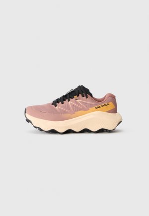 Pink and orange athletic shoes with a mesh upper, thick cream midsole, and black laces and outsole. Features a textured pattern.