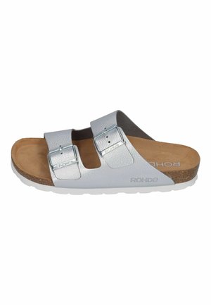 Silver leather slide sandal with double buckle straps, cork footbed, and rubber outsole. Features a smooth texture and contoured shape.