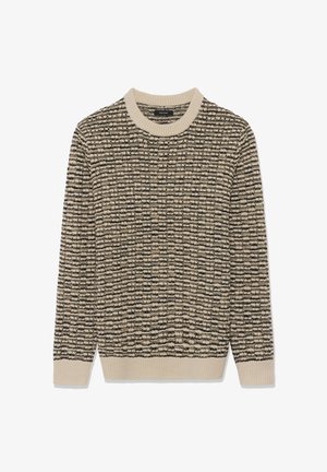 Stickad tröja i krämfärg och svart, med ett texturerat mönster. Ribbad rundhals och manschetter ger ökad struktur. Mjuk, medelvikts tyg.