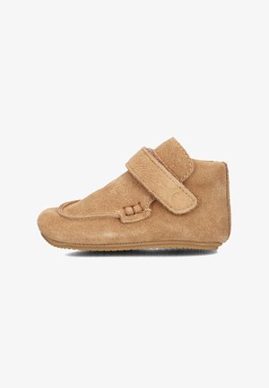 Tan suede toddler shoe with rounded toe, Velcro strap, and stitched details. Soft texture, flexible rubber sole for comfort.