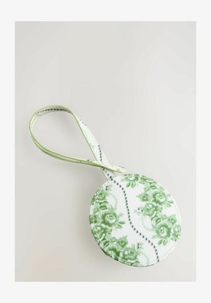 Kerek tasak, zöld virágmintával fehér alapon, világoszöld pánttal és kontrasztos varrással.