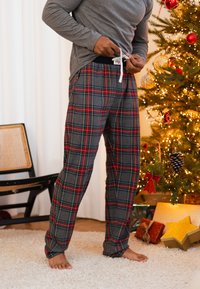 Gray long-sleeve shirt and plaid lounge pants featuring blue, red, and green stripes, with an elastic waistband and tie for adjustment.