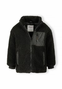 Veste polaire noire pour enfants avec fermeture éclair devant, poche poitrine zippée et détails en nylon sur les poches, étiquetée pour les enfants de 5 à 6 ans.