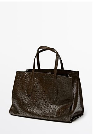 Brown leather tote bag with a textured surface featuring small bumps, two elongated handles, and a spacious open design.