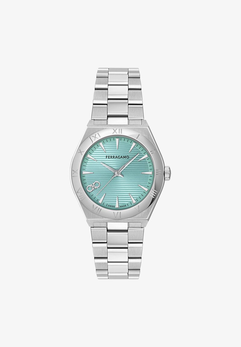 Orologio da polso in metallo argentato con quadrante testurizzato color turchese, indicatori romani argentati e bracciale in acciaio inossidabile.