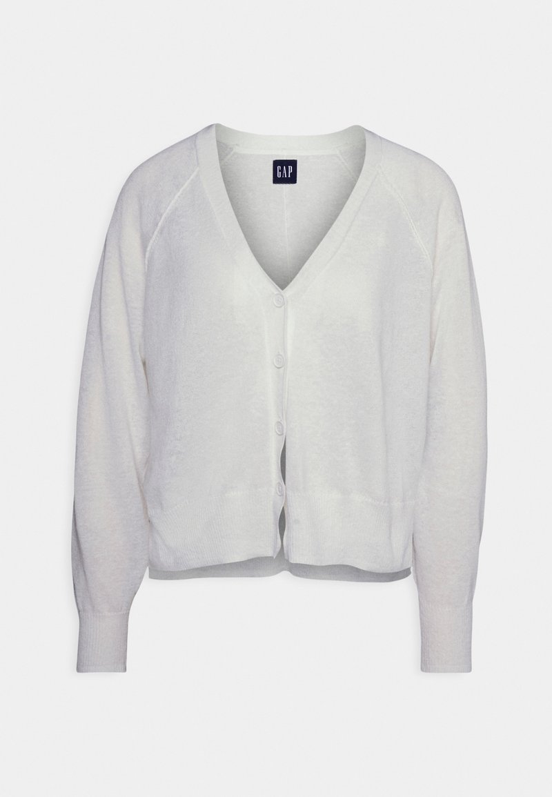Cárdigan blanco, ligero, hecho de material suave. Presenta un escote en V, cierre de botones y puños acanalados. Diseño corto con un corte relajado.