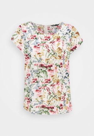Blouse à manches courtes avec encolure ronde présentant un imprimé floral multicolore en tons de rose, vert, jaune et gris sur fond blanc.