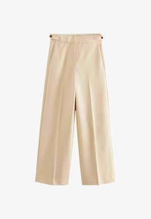 Pantalon beige taille haute à jambes larges avec détails de pattes boutonnées sur le côté et une couture avant épurée et minimaliste.