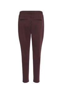 Pantaloni bordeaux realizzati in tessuto elasticizzato, con una silhouette aderente, vita elasticizzata e due tasche posteriori. Texture liscia.