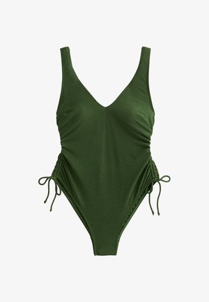 Maillot de bain une pièce vert olive avec un décolleté en V, des côtés froncés et des liens réglables. Fabriqué en tissu texturé, avec une coupe haute sur les jambes.