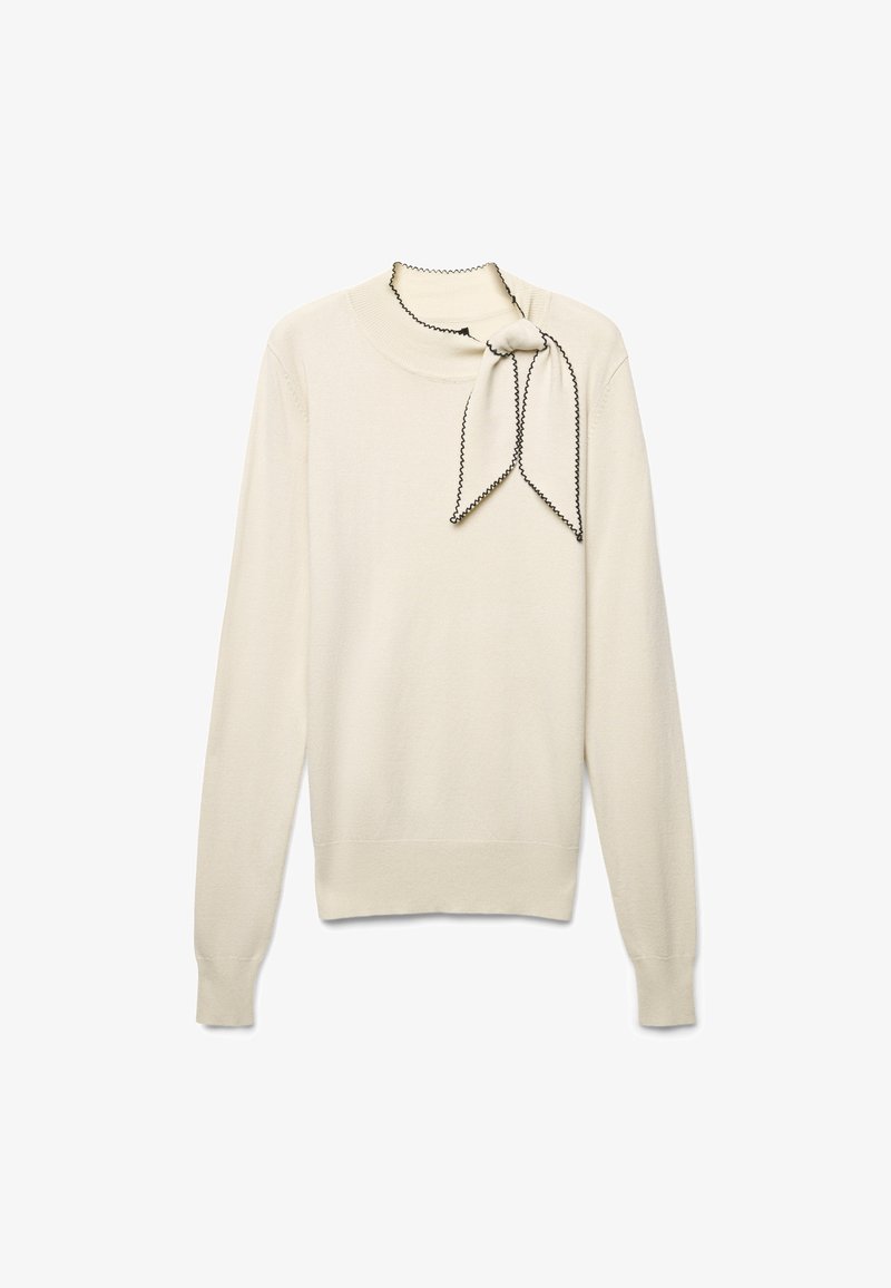 Pull crème avec un col rond et des manches longues. Il présente un nœud décoratif au niveau du cou avec des bordures noires contrastantes.