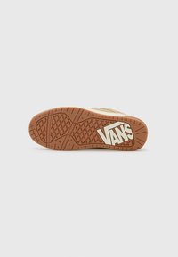 Gumeni potplat Vans tenisica, s uzorkom u smeđoj boji, bijelim logotipom i teksturiranom površinom za bolji grip.