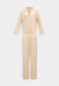 Bézs színű hosszú ujjú gombos pizsama felső gallérral és mellzsebbel, hozzáillő, laza szabású, elasztikus derékpántos nadrággal.