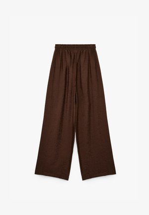 Pantalones marrones de pierna ancha con cintura elástica, que presentan una tela texturizada con un sutil patrón de hojas. Corte holgado y diseño de largo completo.