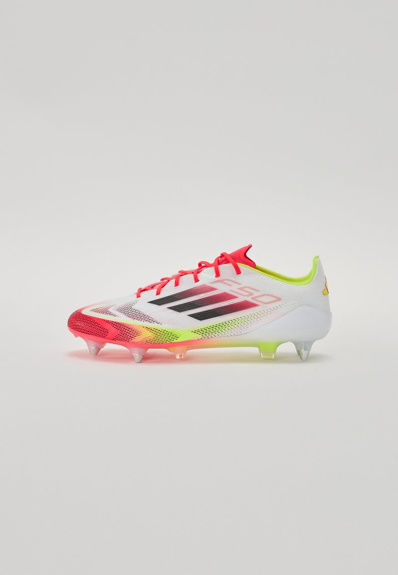 White soccer cleat with pink and neon yellow accents, mesh upper, black stripes, and translucent cleats. Lightweight design for performance.