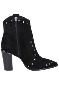 Bottines en suede noir avec des clous argentés sur le côté, bout pointu et fermeture éclair. Elles sont dotées d'un talon épais noir pour plus de stabilité.