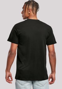 Black cotton t-shirt with a crew neck and short sleeves, featuring a smooth texture and a relaxed fit, viewed from the back.