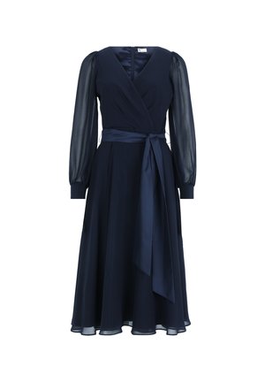 Navy blue wrap dress with long sheer sleeves, a tie belt at the waist, and a flowy skirt. Features a deep V-neck and smooth fabric texture.