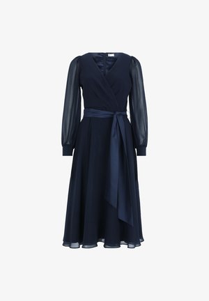 Navy blue wrap dress with long sheer sleeves, a tie belt at the waist, and a flowy skirt. Features a deep V-neck and smooth fabric texture.