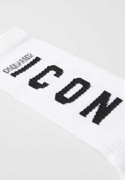 White sock with black text reading "ICON," featuring ribbed texture and contrasting colors. Distinct branding along the top.