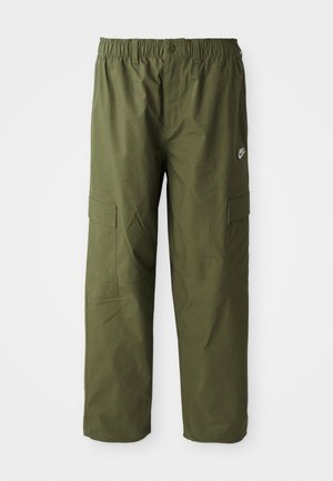 Nike cargo pants in dark olive green, featuring an elastic waistband, two side pockets, and a smooth, lightweight fabric.