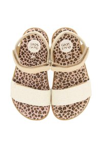 Sandalias beige con una correa brillante y plantilla de estampado de leopardo, que cuentan con correas ajustables en el tobillo y un diseño de suela plana. Talla 26.