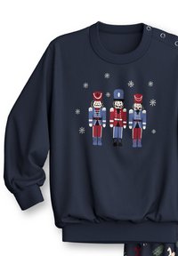 Marineblauwe sweatshirt met een notenkrakerontwerp in rood, blauw en wit, versierd met sneeuwvlokken. Geribbelde manchetten en zoom, met een zachte textuur.