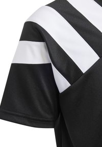 T-shirt de sport noir avec de larges rayures blanches sur les épaules. Fabriqué en tissu respirant avec une texture lisse, conçu pour le confort.